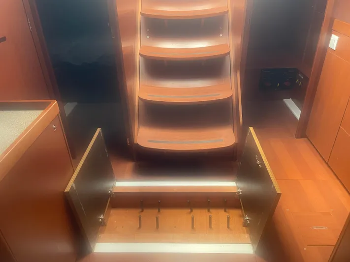 Danmark Yacht Photos Pics Interior of 2019 Beneteau Oceanis 41.1 yacht with wooden steps and open storage compartment.