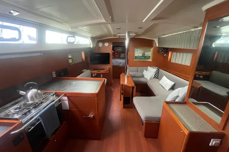 Danmark Yacht Photos Pics Luxurious interior of 2019 Beneteau Oceanis 41.1 yacht with modern kitchen and cozy seating area.