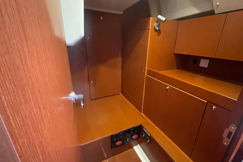 Danmark Yacht Photos Pics Interior of 2019 Beneteau Oceanis 41.1 yacht with wooden cabinetry and storage space.
