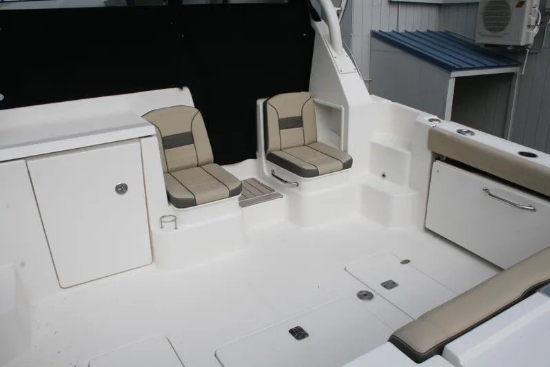 Skye Boat Yacht Photos Pics 2020 Pursuit OS 355 Offshore boat interior with seating and storage compartments.