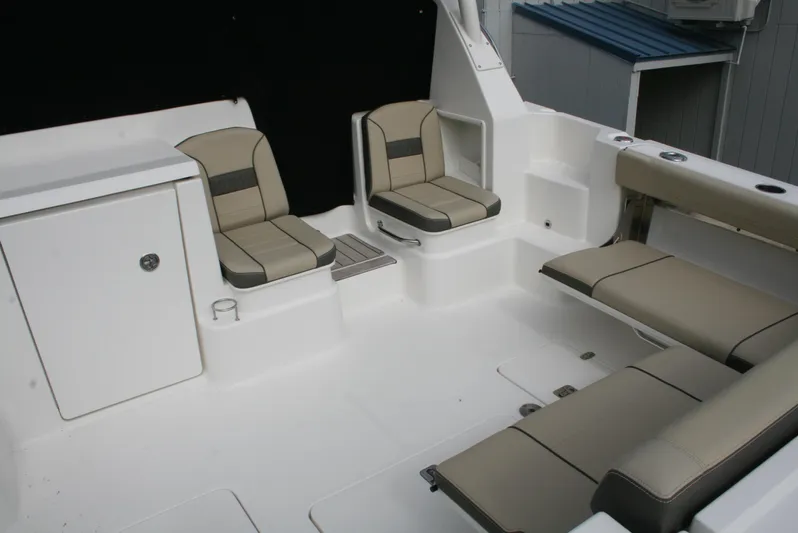 Skye Boat Yacht Photos Pics 2020 Pursuit OS 355 Offshore boat interior with beige seating and storage compartments.