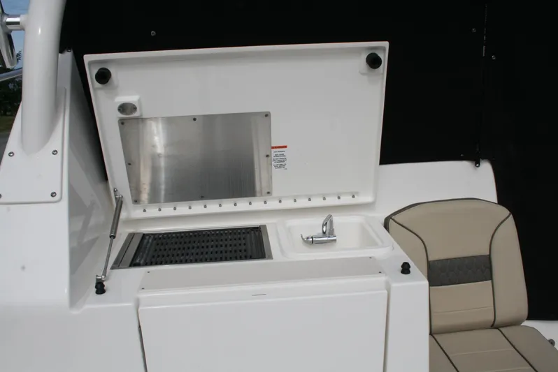 Skye Boat Yacht Photos Pics 2020 Pursuit OS 355 Offshore boat interior with sink and seating area.