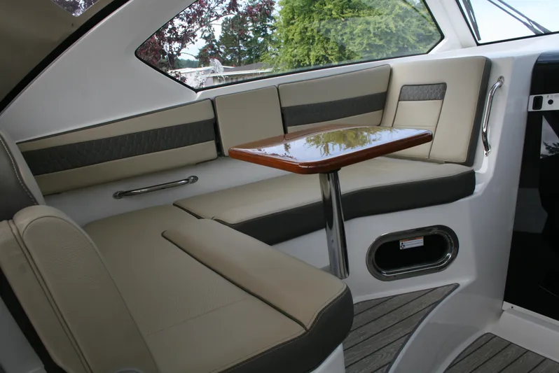 Skye Boat Yacht Photos Pics 2020 Pursuit OS 355 Offshore interior with elegant seating and wooden table.