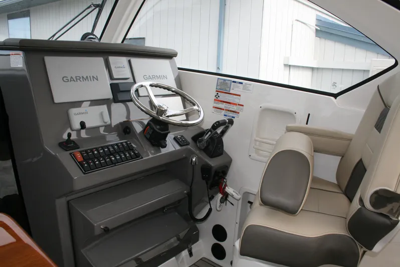 Skye Boat Yacht Photos Pics 2020 Pursuit OS 355 Offshore helm with Garmin navigation and comfortable seating.