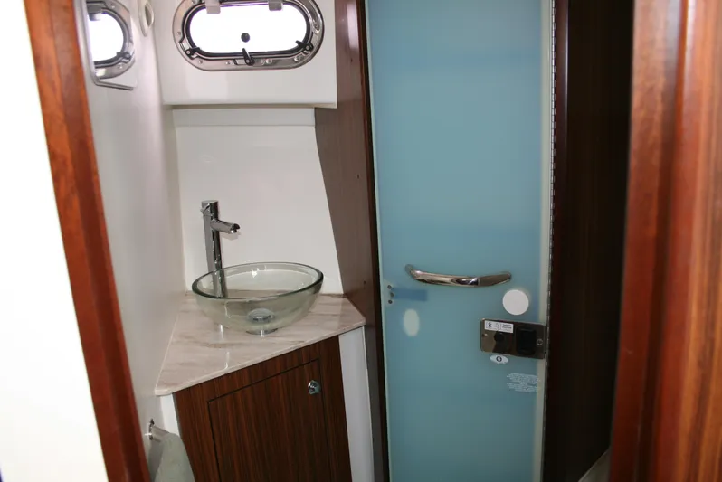 Skye Boat Yacht Photos Pics 2020 Pursuit OS 355 Offshore bathroom with glass sink and modern fixtures.