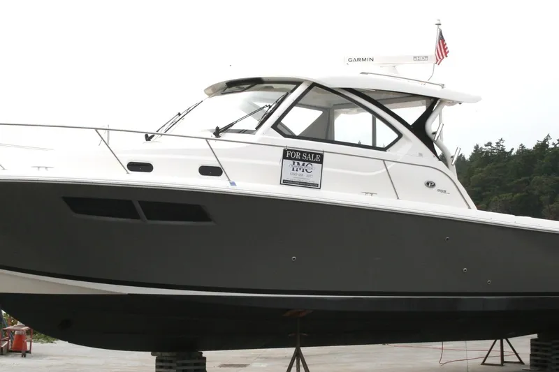 Skye Boat Yacht Photos Pics 2020 Pursuit OS 355 Offshore boat for sale, displayed on a stand.