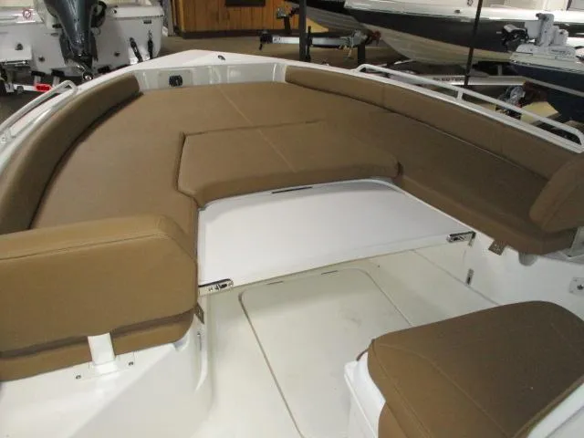 2025 Skeeter SX2550 boat interior with brown cushioned seating and white deck.
