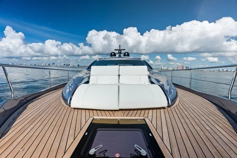 Barnext Yacht Photos Pics Luxury Pershing 7X yacht deck with sun loungers, ocean view, and city skyline, 2025 model.