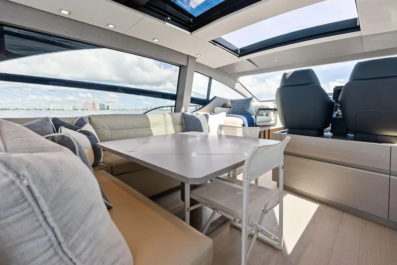 Barnext Yacht Photos Pics Luxurious interior of 2025 Pershing 7X yacht with modern seating and panoramic windows.