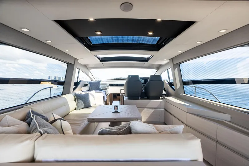 Barnext Yacht Photos Pics Luxurious interior of 2025 Pershing 7X yacht with modern seating and panoramic windows.