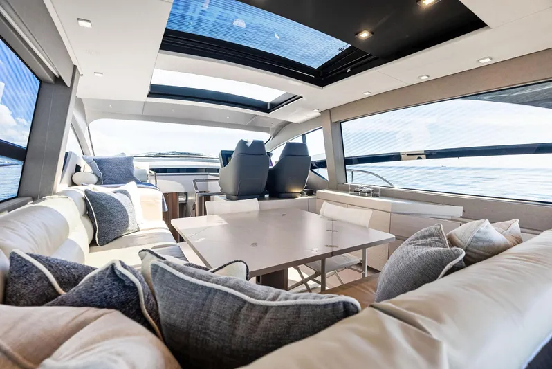 Barnext Yacht Photos Pics Luxurious interior of 2025 Pershing 7X yacht with modern seating and panoramic windows.