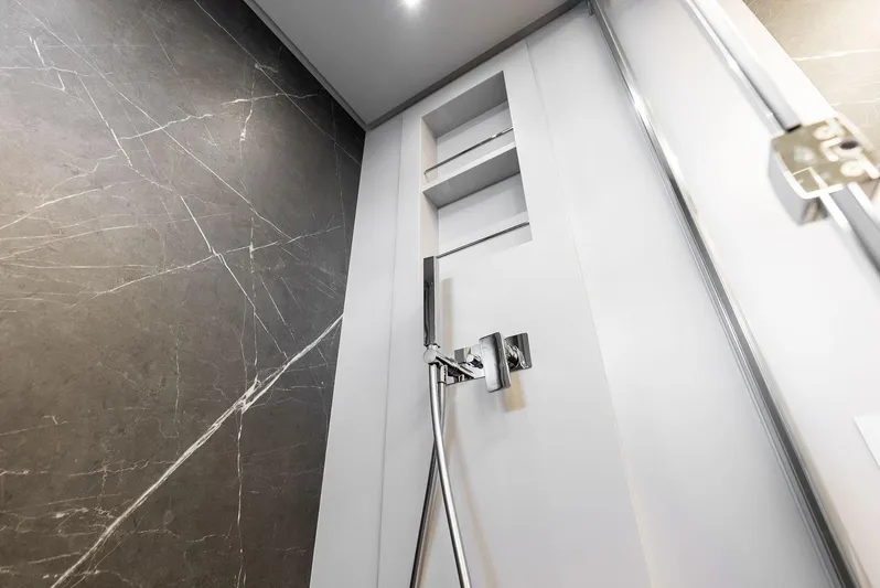 Barnext Yacht Photos Pics Modern shower design in Pershing 7X yacht, featuring sleek fixtures and marble wall.