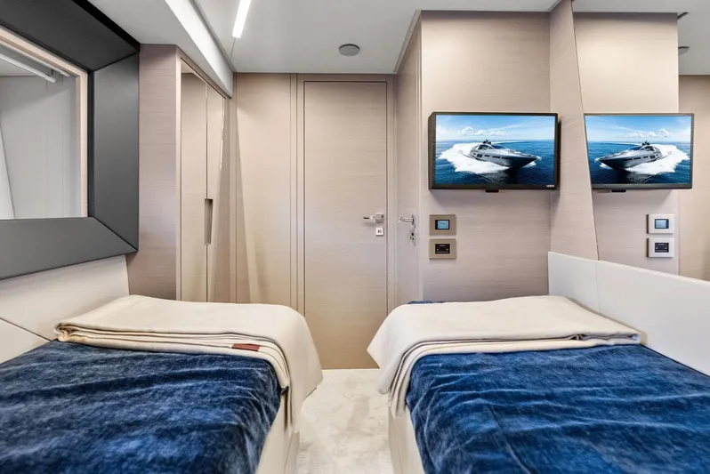 Barnext Yacht Photos Pics Luxurious twin cabin interior of 2025 Pershing 7X yacht with modern decor and dual TVs.