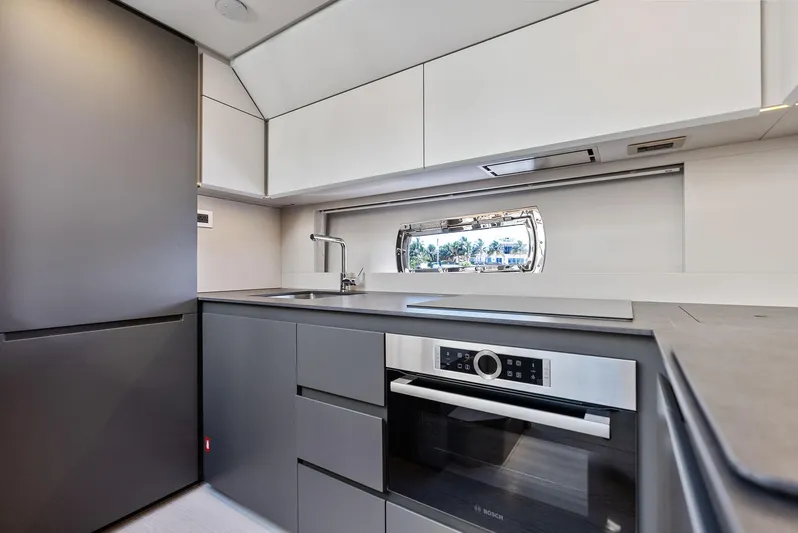 Barnext Yacht Photos Pics Modern kitchen interior in 2025 Pershing 7X yacht, featuring sleek cabinetry and appliances.