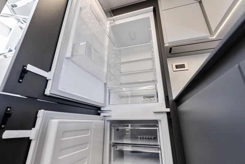 Barnext Yacht Photos Pics Modern kitchen with open refrigerator in Pershing 7X yacht, 2025 model.