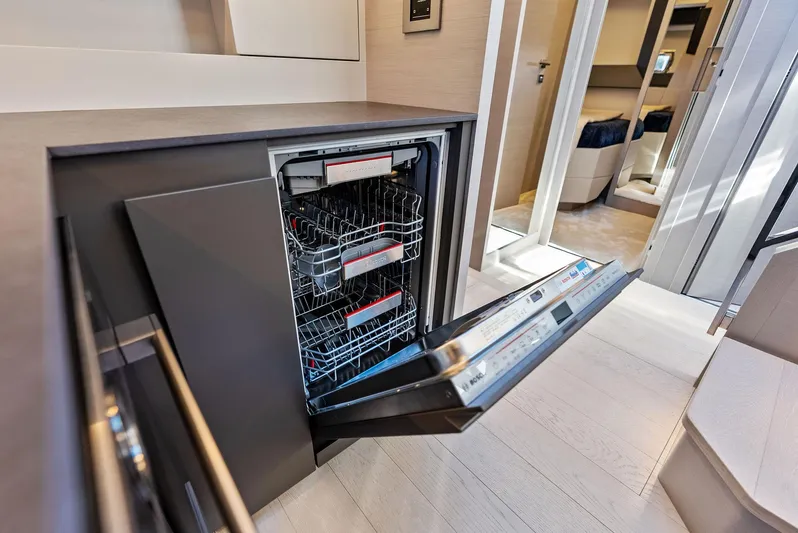Barnext Yacht Photos Pics Open dishwasher in modern kitchen on Pershing 7X yacht, 2025 model.