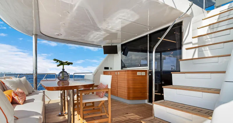 Clb65 Yacht Photos Pics Luxurious 2024 CL Yachts CLB65 yacht deck with seating, table, and ocean view.