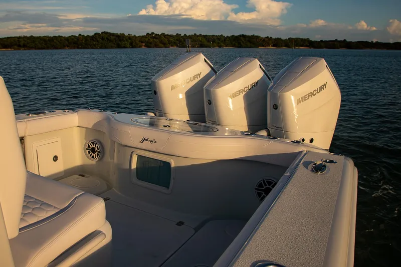 New Stock Yacht Photos Pics 2026 Yellowfin 36 Offshore boat with triple Mercury engines on calm water.