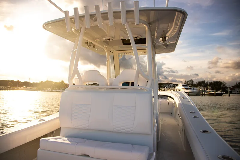 New Stock Yacht Photos Pics 2026 Yellowfin 36 Offshore boat interior at sunset, showcasing luxury seating and design.
