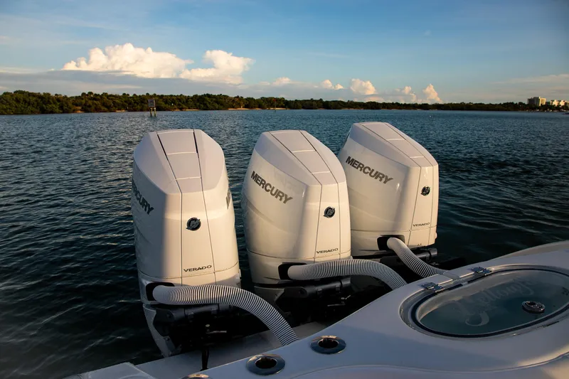New Stock Yacht Photos Pics 2026 Yellowfin 36 Offshore boat with triple Mercury Verado engines on a serene water backdrop.