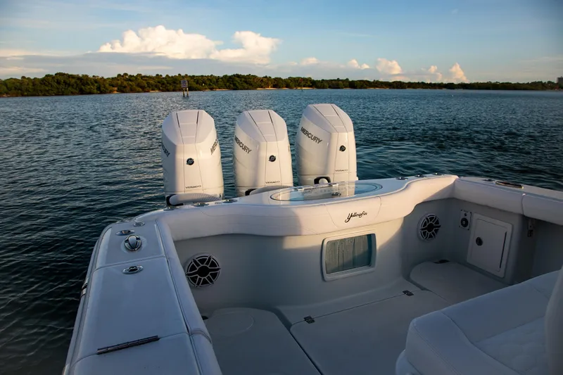 New Stock Yacht Photos Pics 2026 Yellowfin 36 Offshore boat with triple Mercury engines on calm water.
