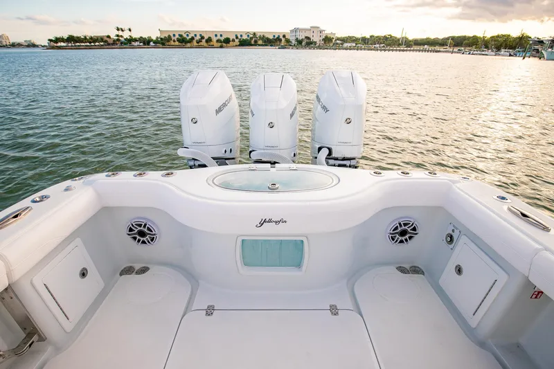 New Stock Yacht Photos Pics 2026 Yellowfin 36 Offshore boat with triple Mercury engines on calm water.