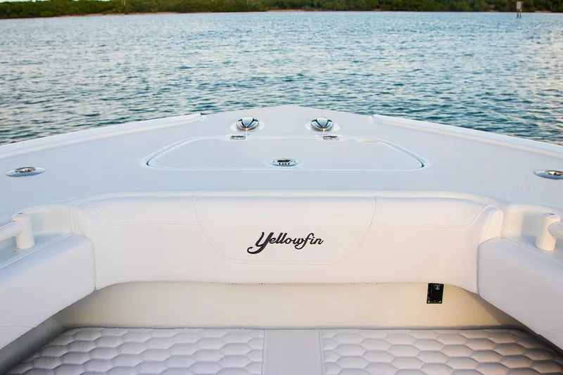 New Stock Yacht Photos Pics 2026 Yellowfin 36 Offshore boat interior with white seating, on calm water.