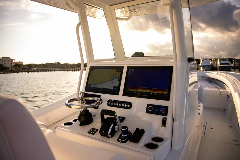 New Stock Yacht Photos Pics 2026 Yellowfin 36 Offshore boat cockpit with advanced navigation systems at sunset.