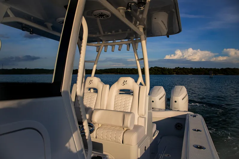 New Stock Yacht Photos Pics 2026 Yellowfin 36 Offshore boat with luxurious seating and powerful engines on a serene water backdrop.