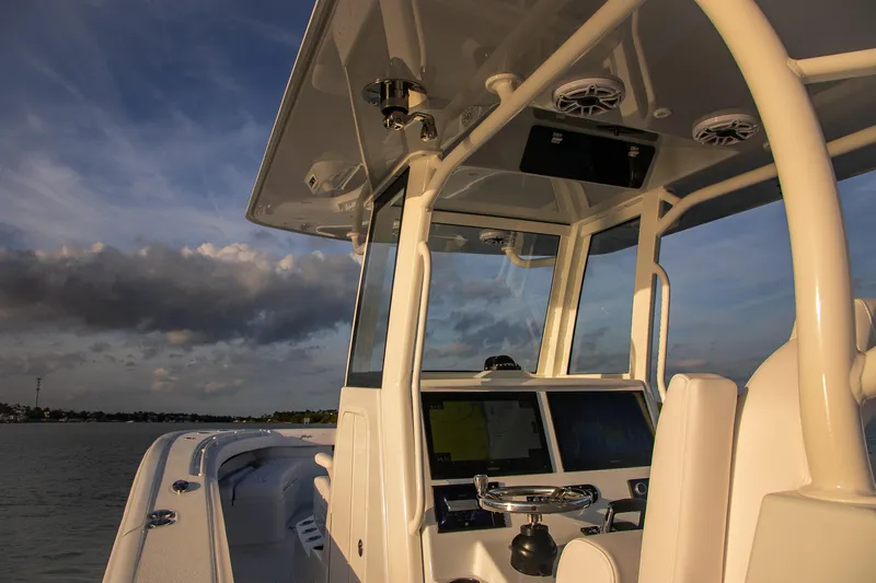 New Stock Yacht Photos Pics 2026 Yellowfin 36 Offshore boat console with modern navigation equipment at sunset.
