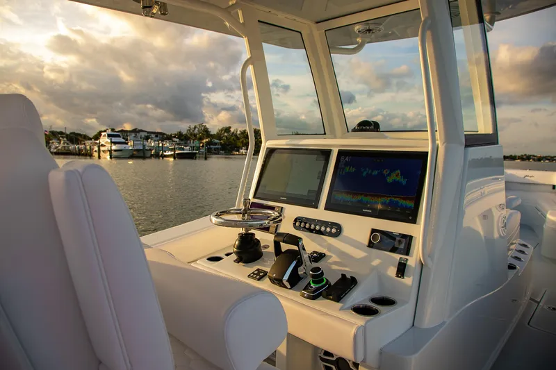 New Stock Yacht Photos Pics 2026 Yellowfin 36 Offshore boat cockpit with advanced navigation systems at sunset.