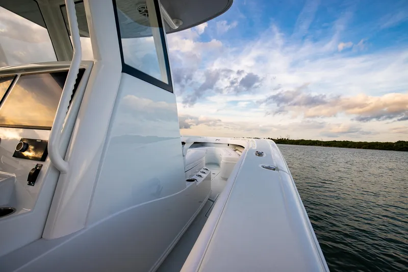 New Stock Yacht Photos Pics 2026 Yellowfin 36 Offshore boat on calm water under a vibrant sky.