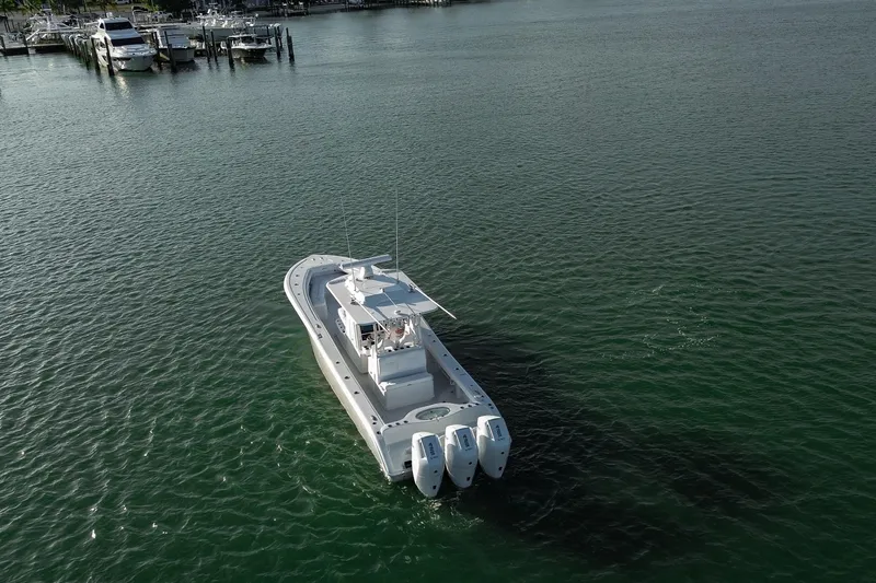 New Stock Yacht Photos Pics 2026 Yellowfin 36 Offshore boat cruising on calm waters near a marina.