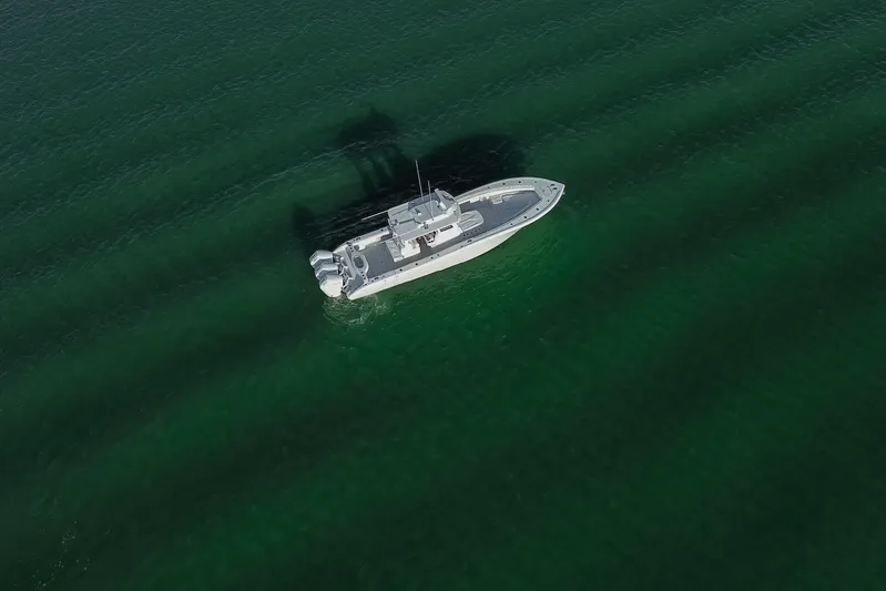New Stock Yacht Photos Pics Aerial view of 2026 Yellowfin 36 Offshore boat on calm green water.
