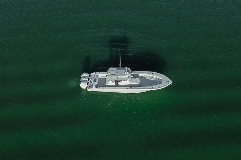 New Stock Yacht Photos Pics Aerial view of 2026 Yellowfin 36 Offshore boat on clear green water.