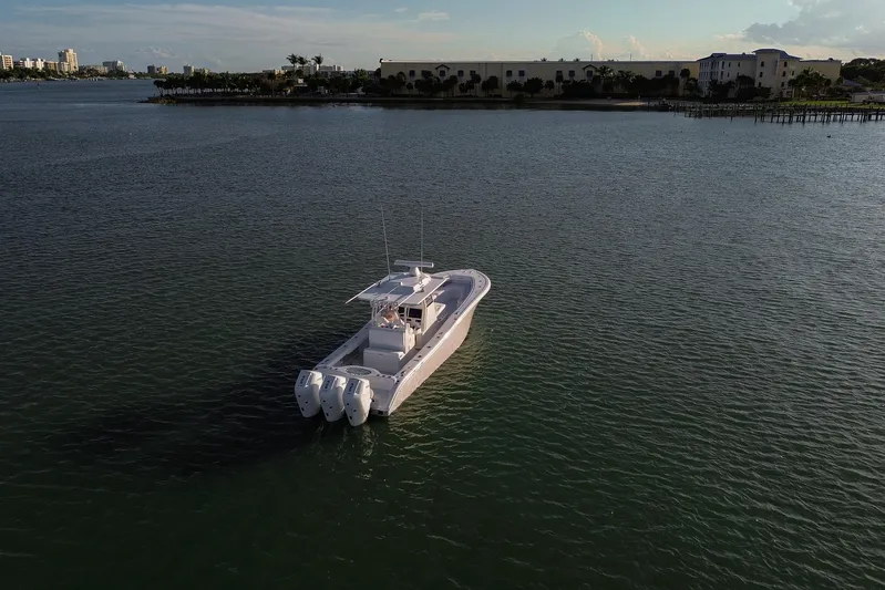 New Stock Yacht Photos Pics 2026 Yellowfin 36 Offshore boat on calm water, distant shoreline view.
