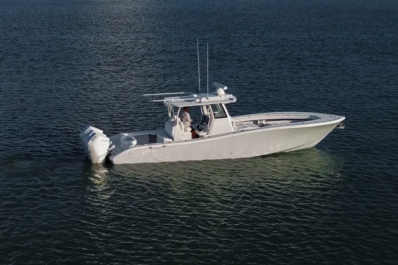 New Stock Yacht Photos Pics 2026 Yellowfin 36 Offshore boat on calm water, side view.