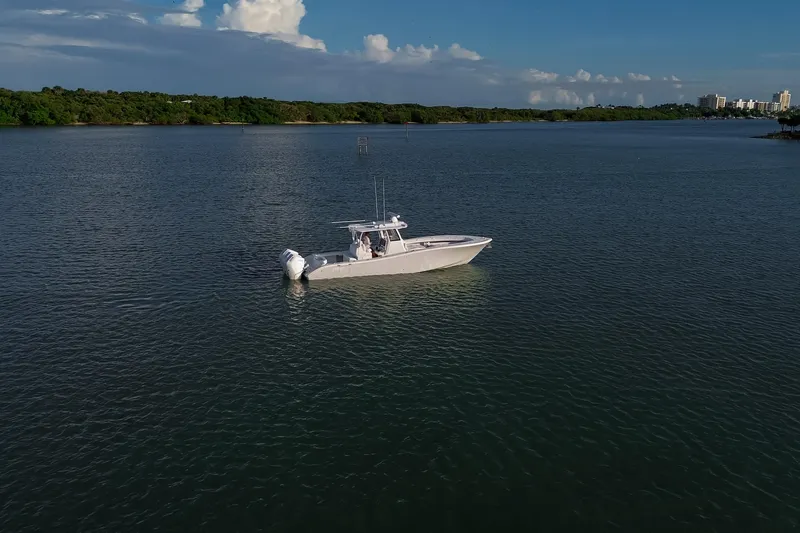 New Stock Yacht Photos Pics 2026 Yellowfin 36 Offshore boat on calm water under a clear sky.