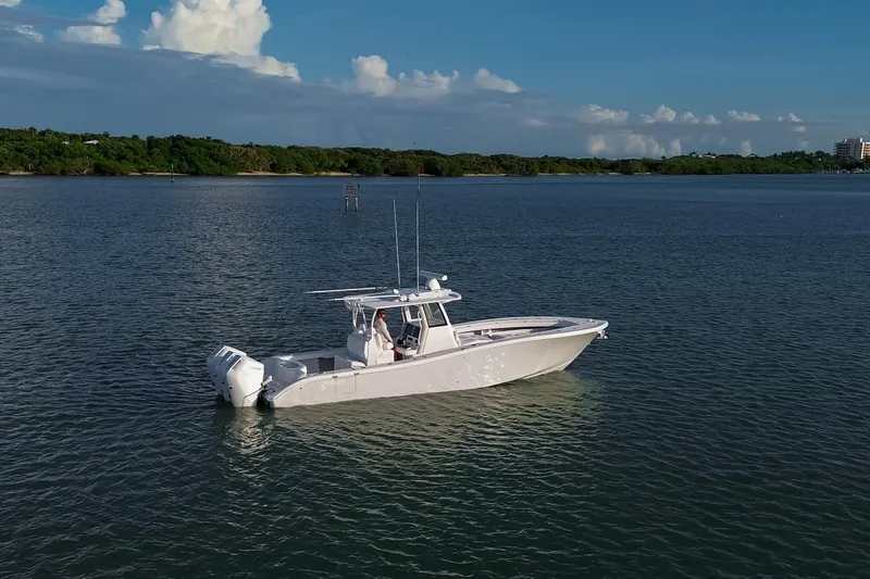 New Stock Yacht Photos Pics 2026 Yellowfin 36 Offshore boat on calm water under a clear blue sky.