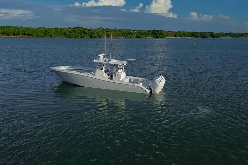 New Stock Yacht Photos Pics 2026 Yellowfin 36 Offshore boat cruising on calm waters under a clear sky.
