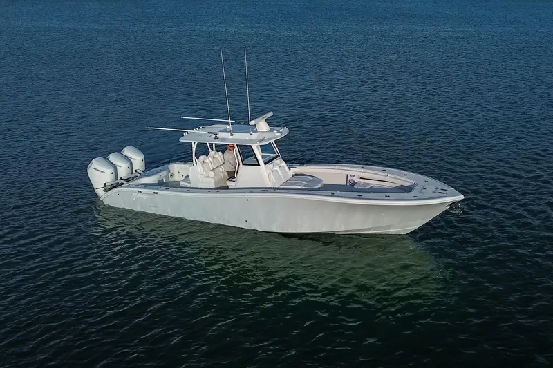 New Stock Yacht Photos Pics 2026 Yellowfin 36 Offshore boat on calm water, featuring triple outboard engines.
