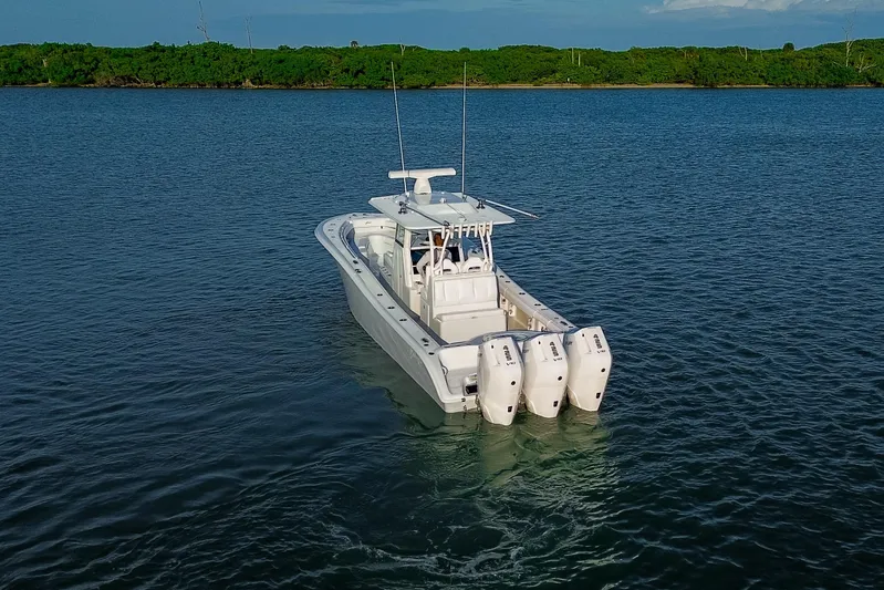 New Stock Yacht Photos Pics 2026 Yellowfin 36 Offshore boat with triple engines on calm water.