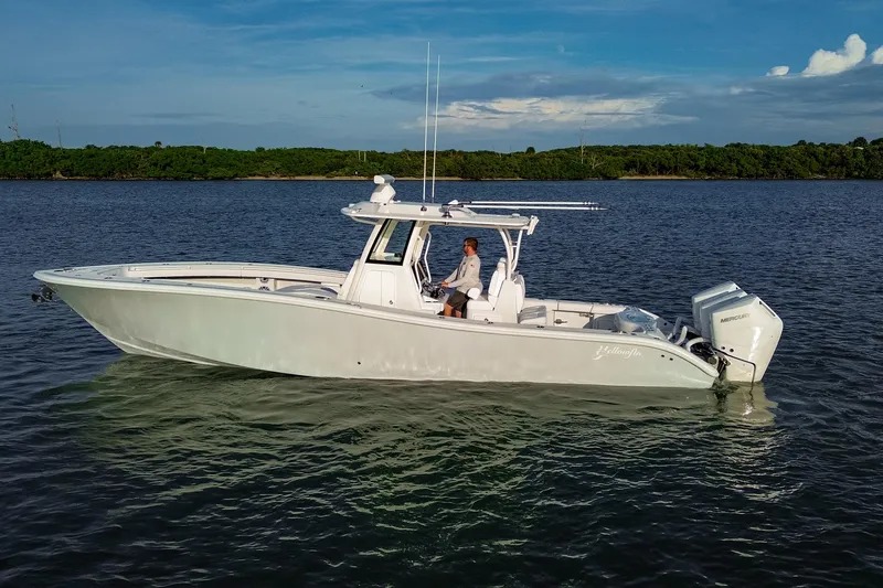 New Stock Yacht Photos Pics 2026 Yellowfin 36 Offshore boat on calm water, featuring sleek design and powerful engines.