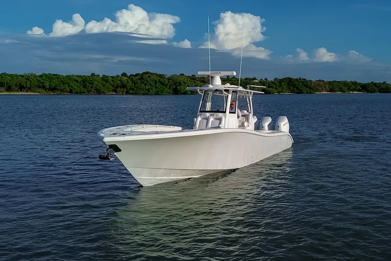 New Stock Yacht Photos Pics 2026 Yellowfin 36 Offshore boat on calm water under a clear blue sky.