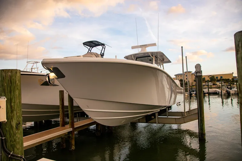 New Stock Yacht Photos Pics 2026 Yellowfin 36 Offshore boat docked at marina during sunset.