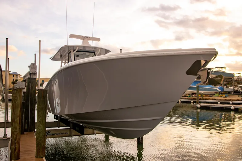 New Stock Yacht Photos Pics 2026 Yellowfin 36 Offshore boat docked at marina during sunset.