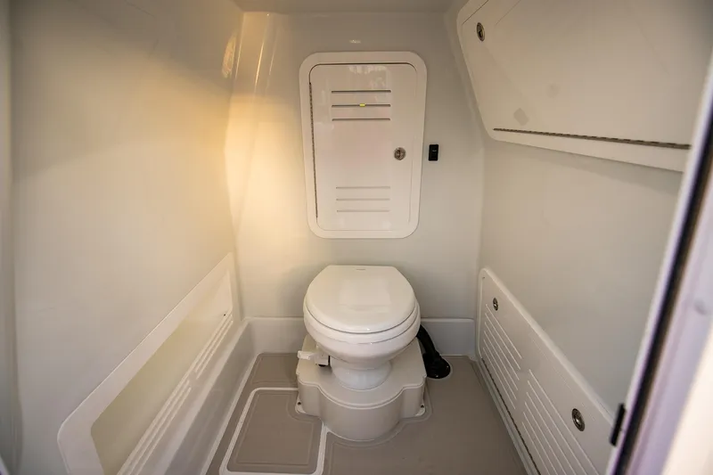 New Stock Yacht Photos Pics 2026 Yellowfin 36 Offshore boat interior bathroom with modern design and compact toilet.