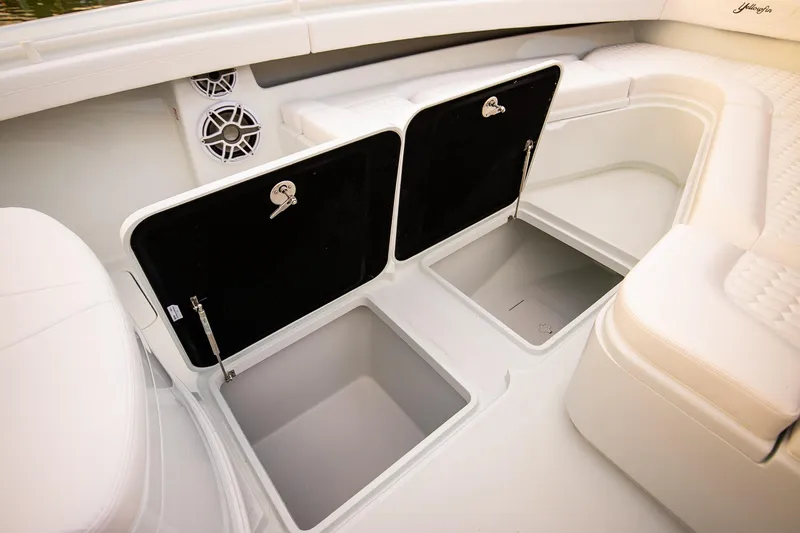 New Stock Yacht Photos Pics 2026 Yellowfin 36 Offshore boat interior with open storage compartments and speakers.
