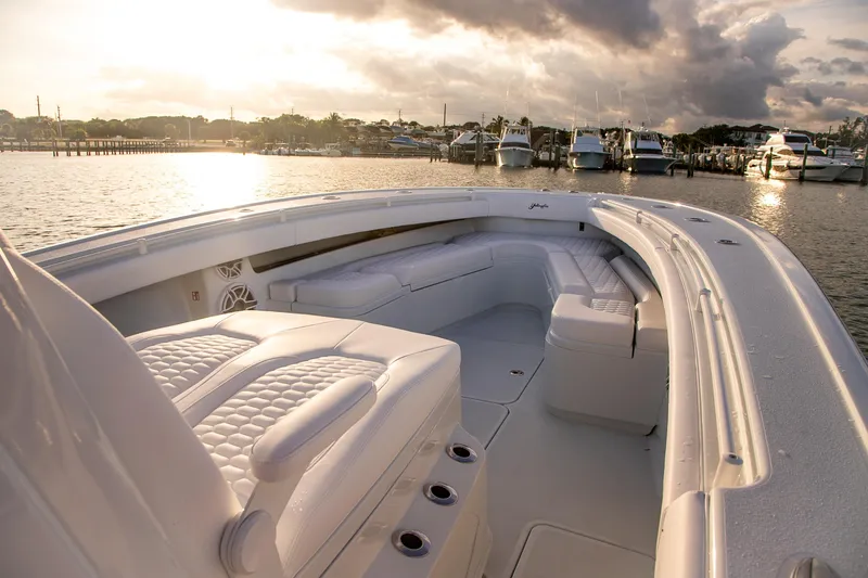 New Stock Yacht Photos Pics 2026 Yellowfin 36 Offshore boat interior at sunset, docked in marina.