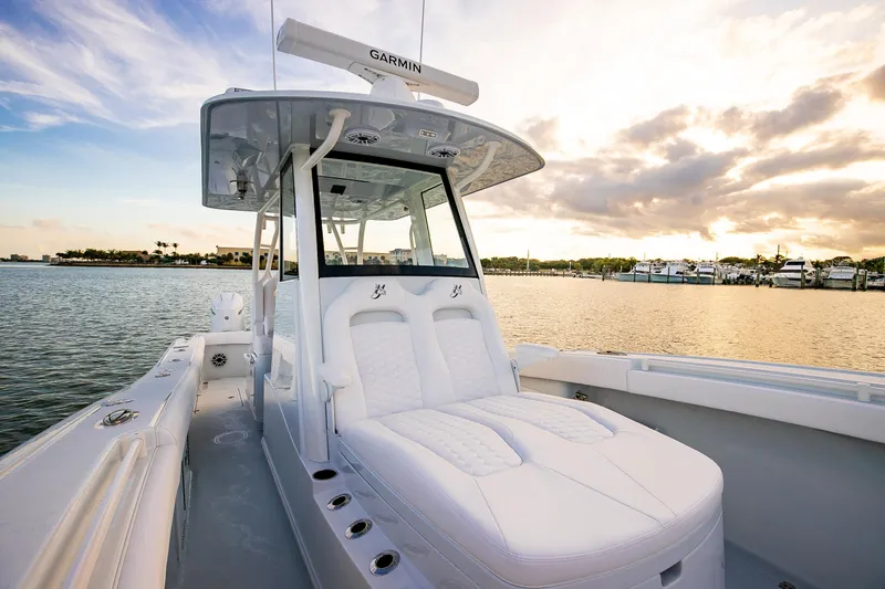 New Stock Yacht Photos Pics 2026 Yellowfin 36 Offshore boat on calm water at sunset.